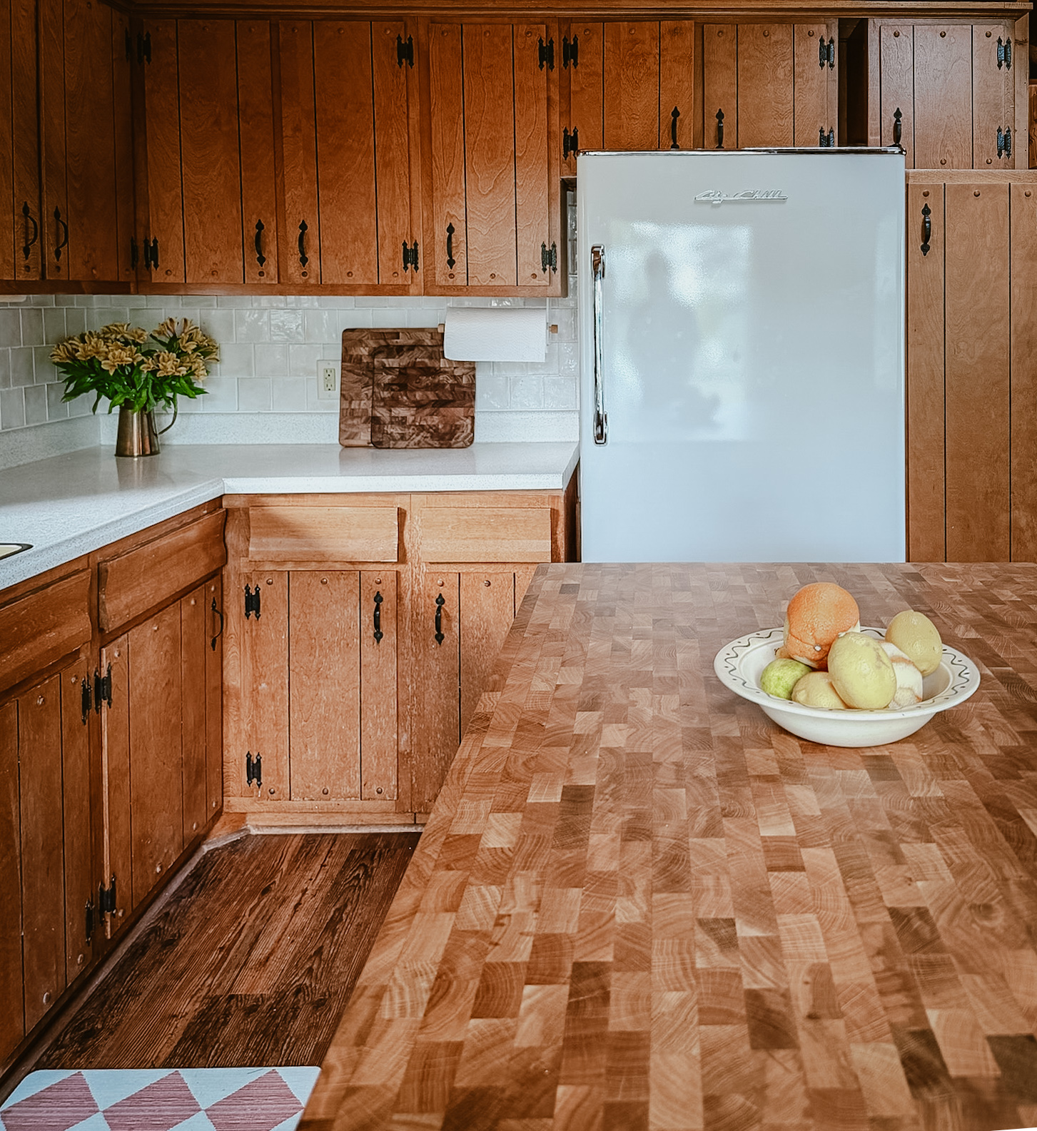 The butcher-block kitchen island and full-size refrigerator