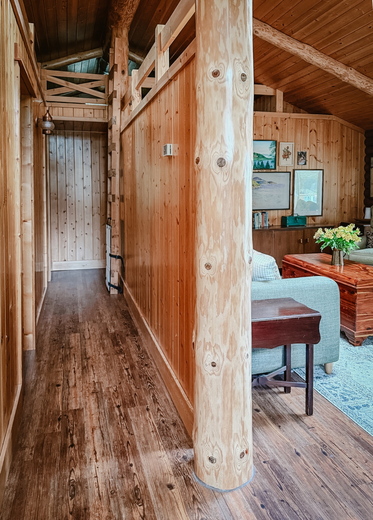 The log-and-pine hallway opening into the living room